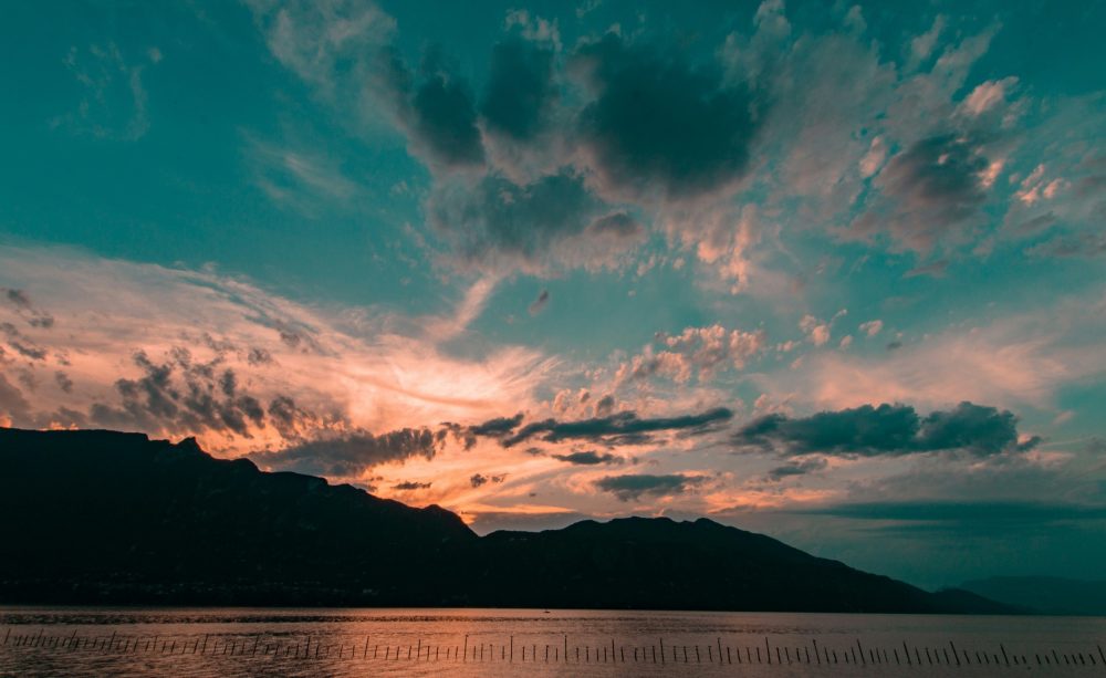 Coucher de Soleil Dramatique sur Montagnes et Lac Turquoise