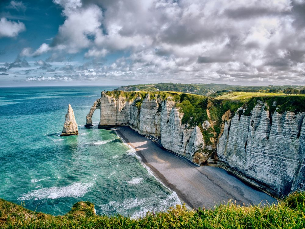 Falaises blanches majestueuses avec arche naturelle et plage secrète
